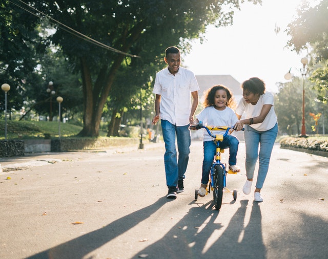 family with child on bike