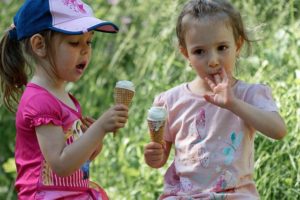 two little girls eating ice cream